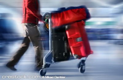 Man with red bags at the airport, motion blur