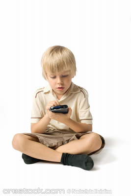 Little boy playing with PDA, studio shot