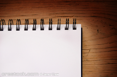 a blank writing pad on a table.