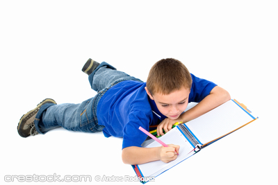 school boy doing homework on the floor isolate...