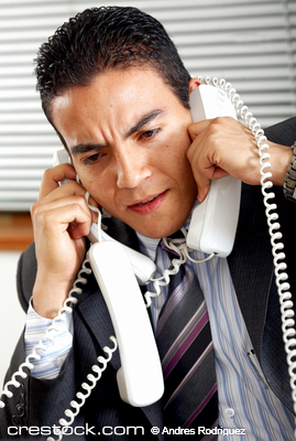 busy business man with many telephones at once