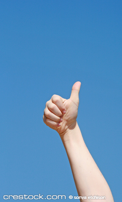 Child Giving a Thumbs Up Against a Clear Blue Sky