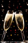 Two champagne glasses making toast over holida...